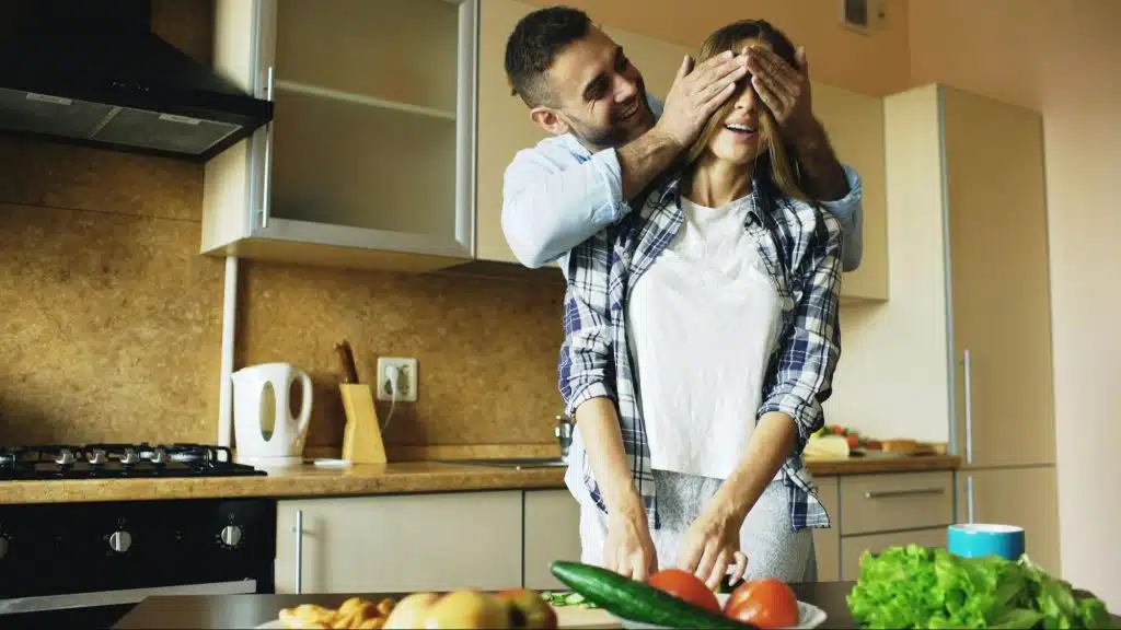 A man covering woman’s eyes