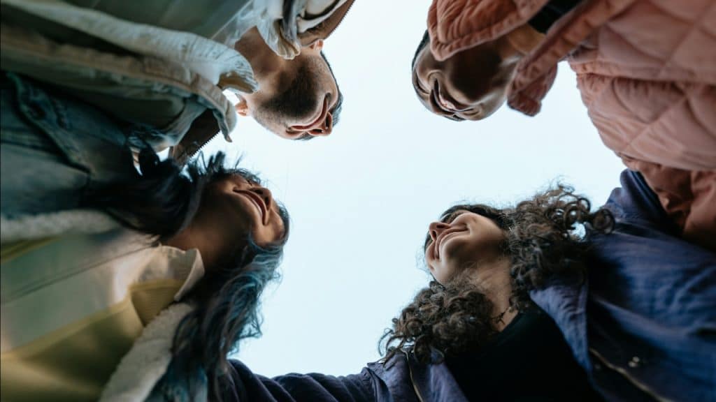 A group of friends standing in a circle.