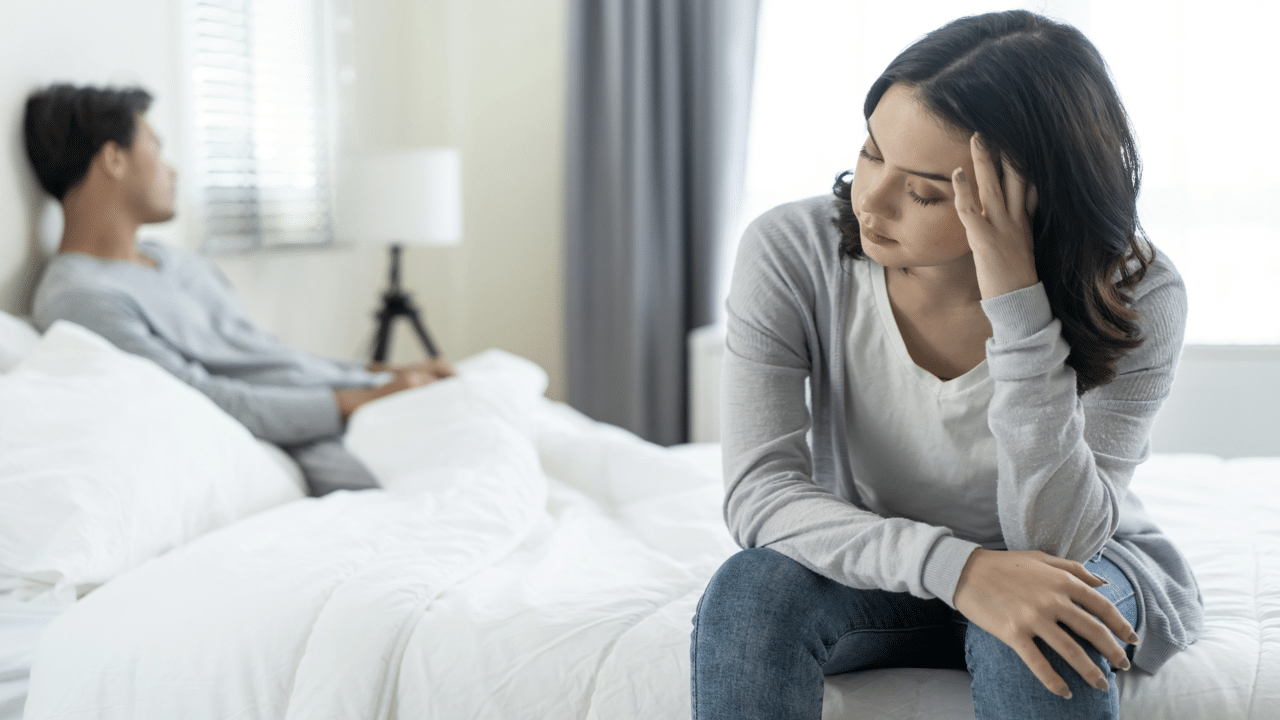A couple ignoring each other in the bedroom