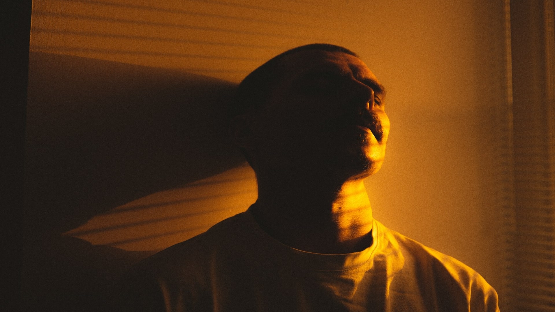 man reflecting near window