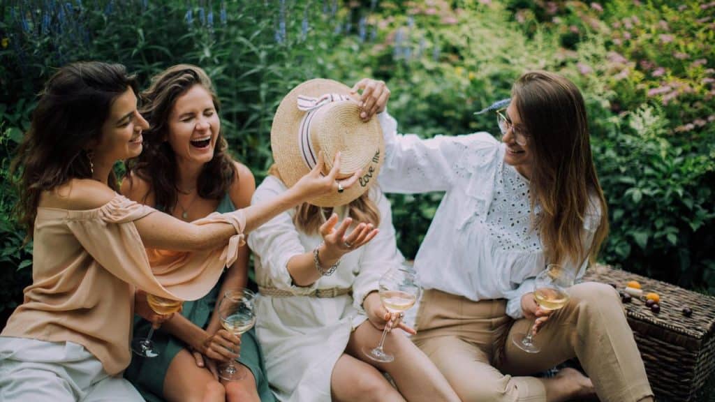 A group of friends laughing together in a garden.