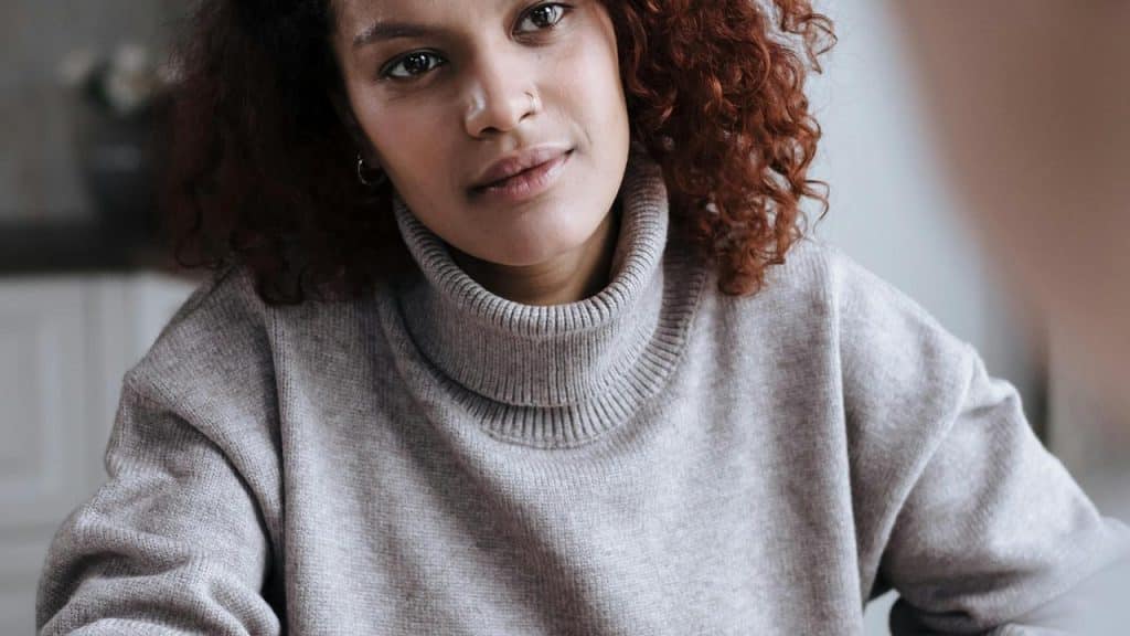 A woman with curly hair looking forward