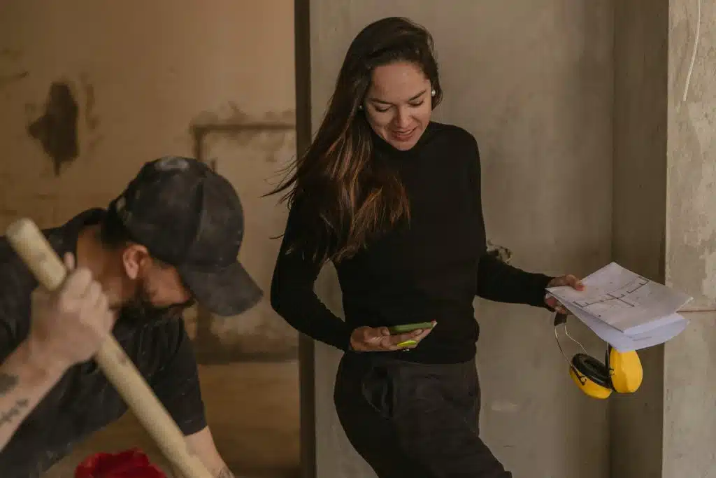 A man and a woman standing in a construction area.