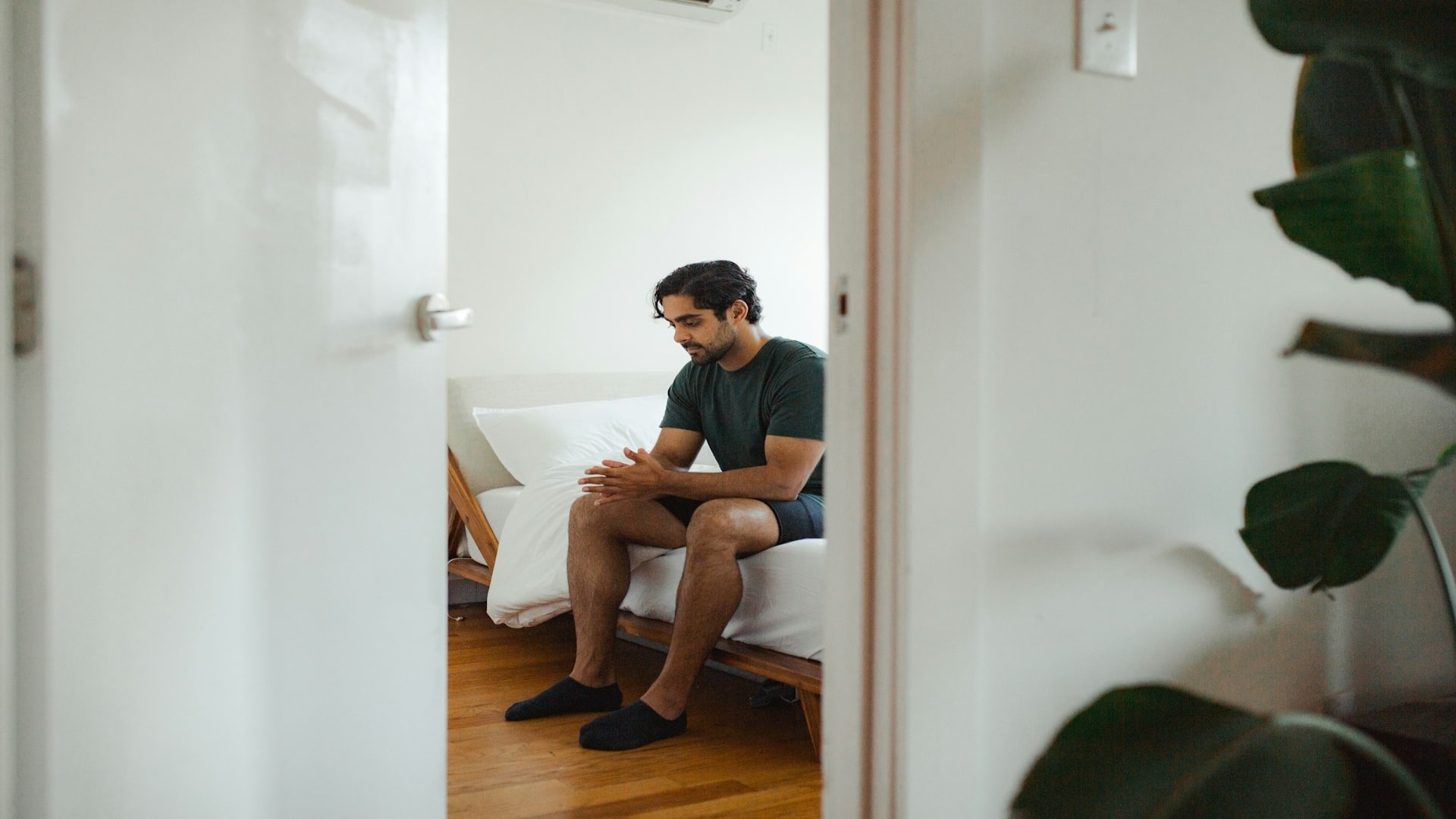 man thinking quietly indoors