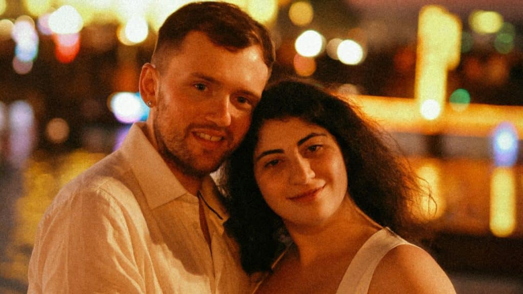 A couple standing close to each other.