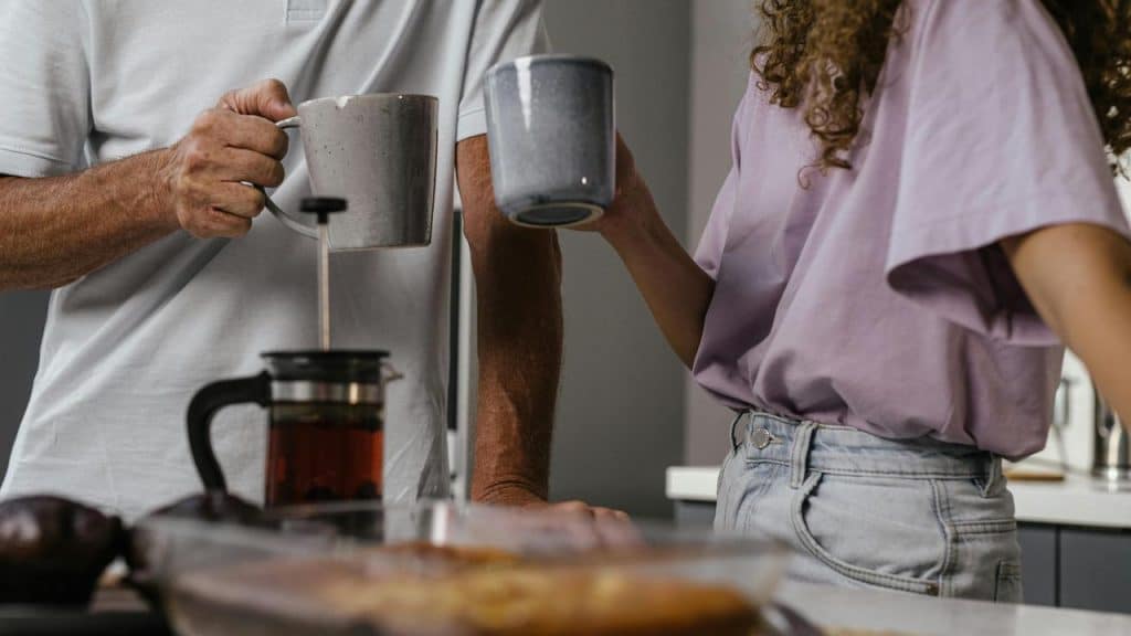 A man and woman holding mugs 