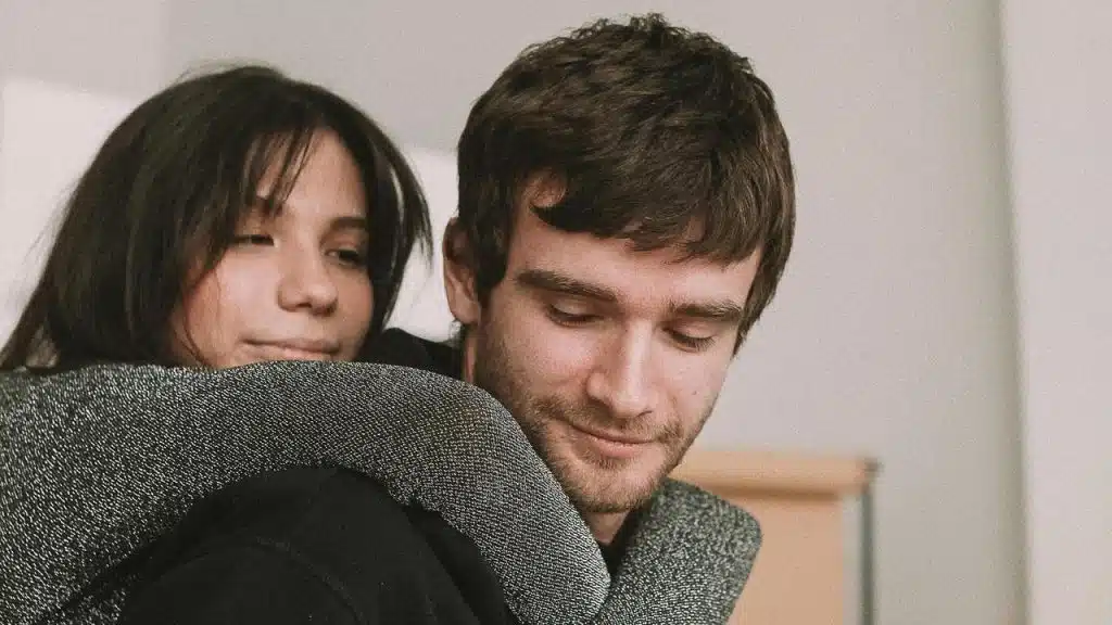 A woman hugging a man from behind.