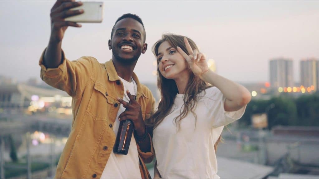 A man taking a picture with woman