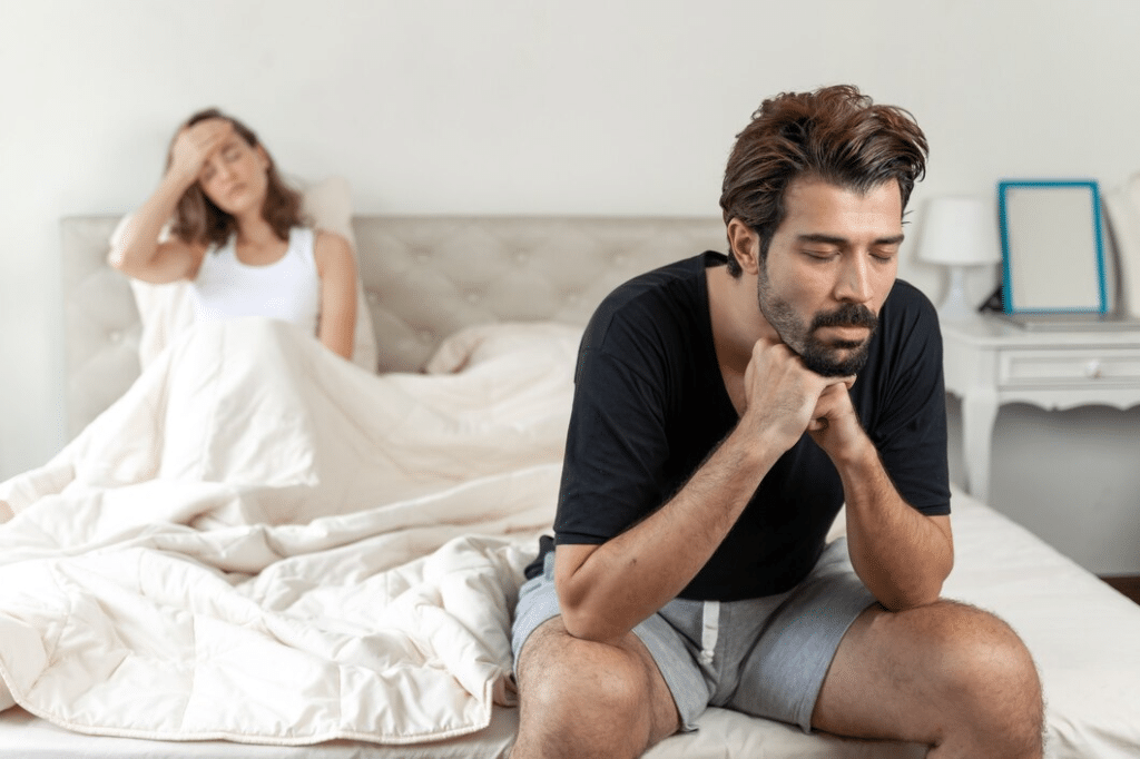 Selective husband sitting on bed