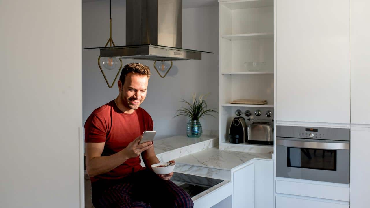 A man sitting in a modern kitchen