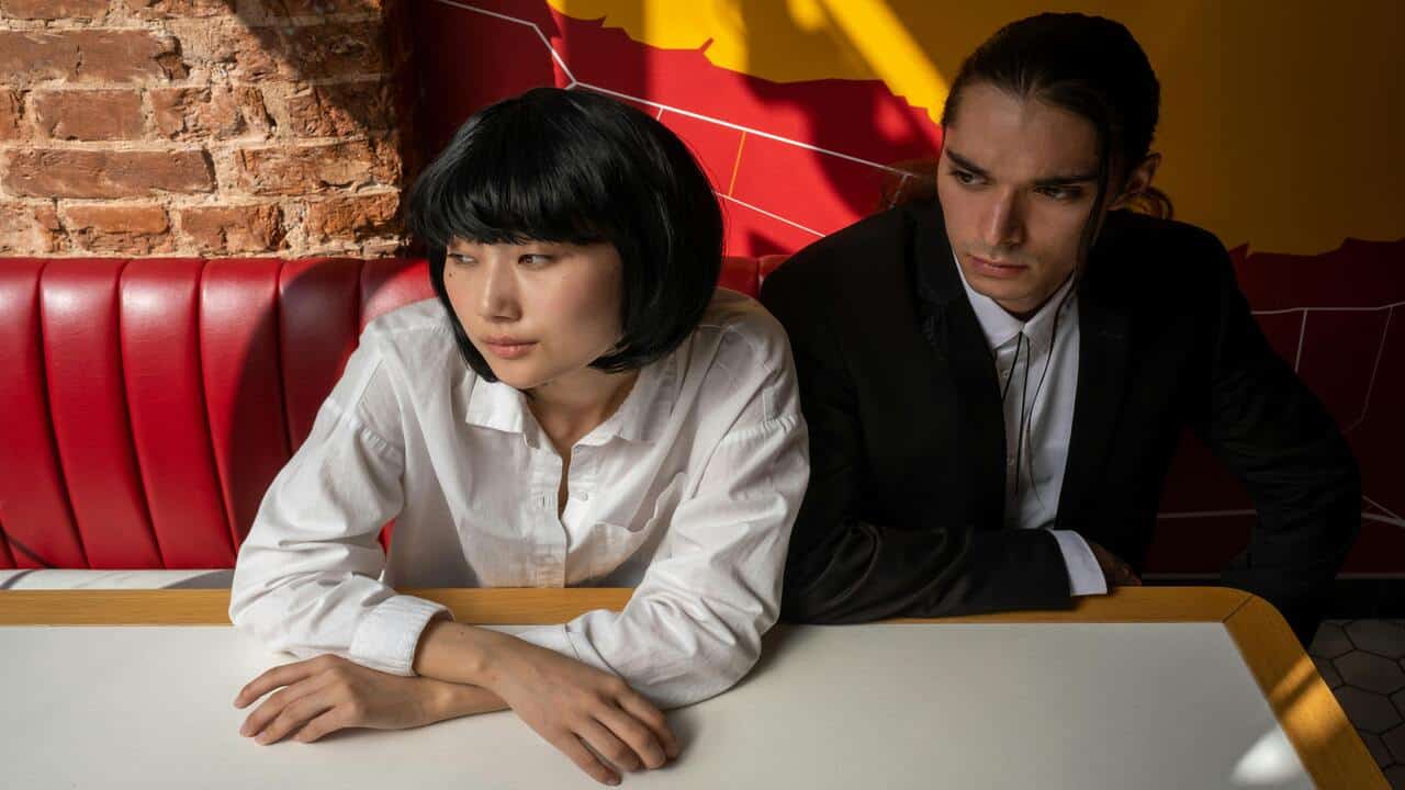 A couple looking serious at a restaurant
