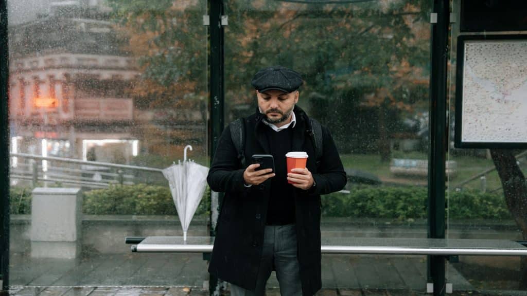 man holding smartphone thoughtfully