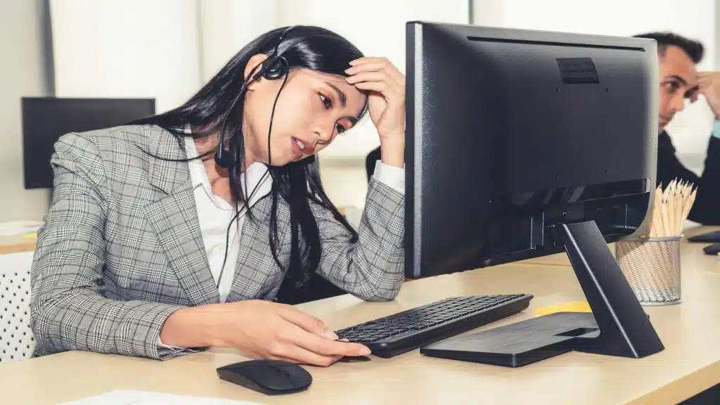 person looking stressed at desk