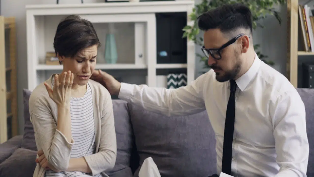 A man comforting his wife