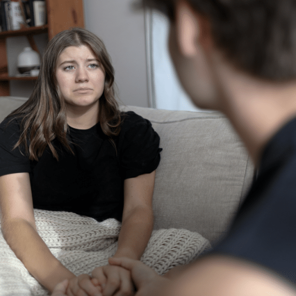 A woman crying in front of her boyfriend
