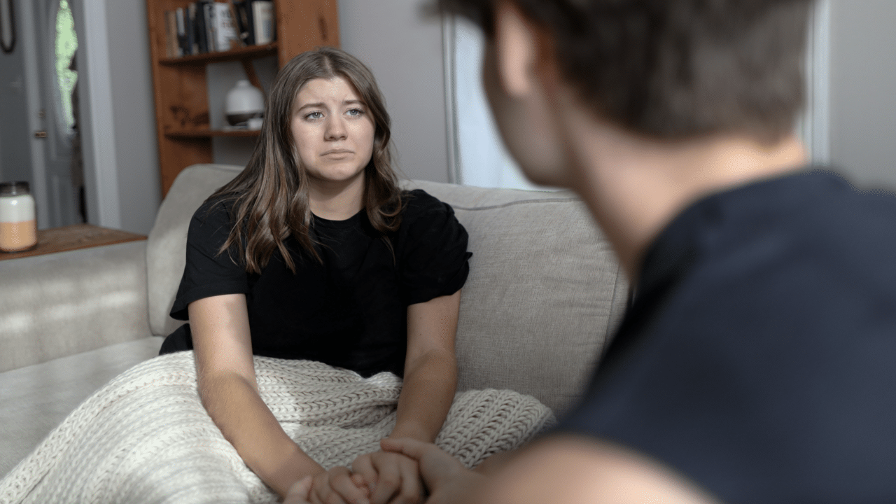A woman crying in front of her boyfriend