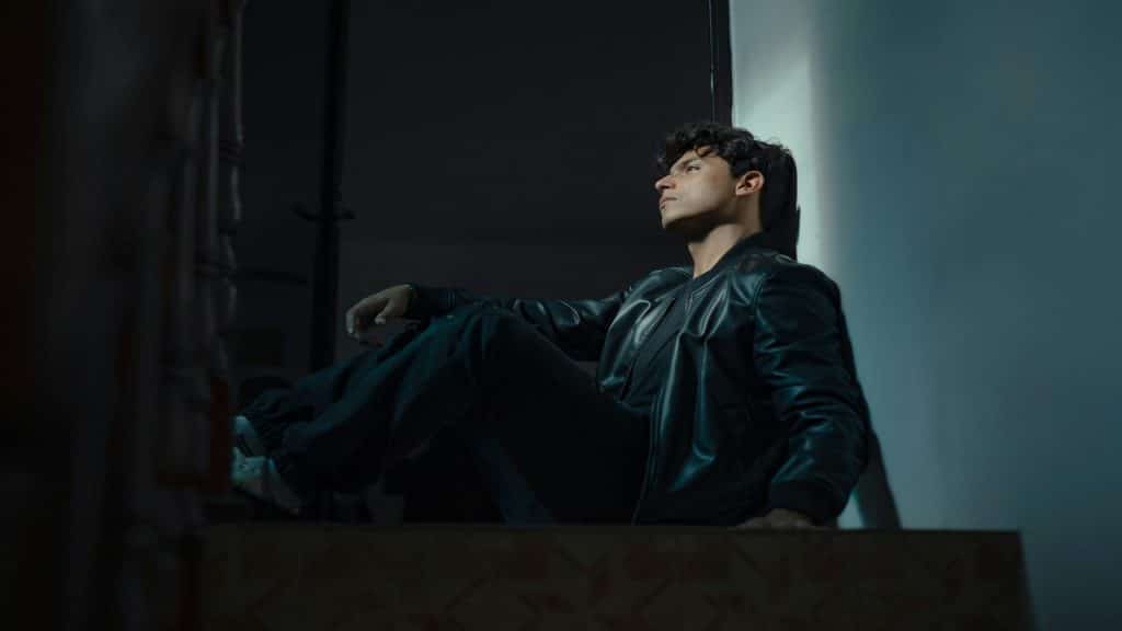 A man looking sad in a dark room