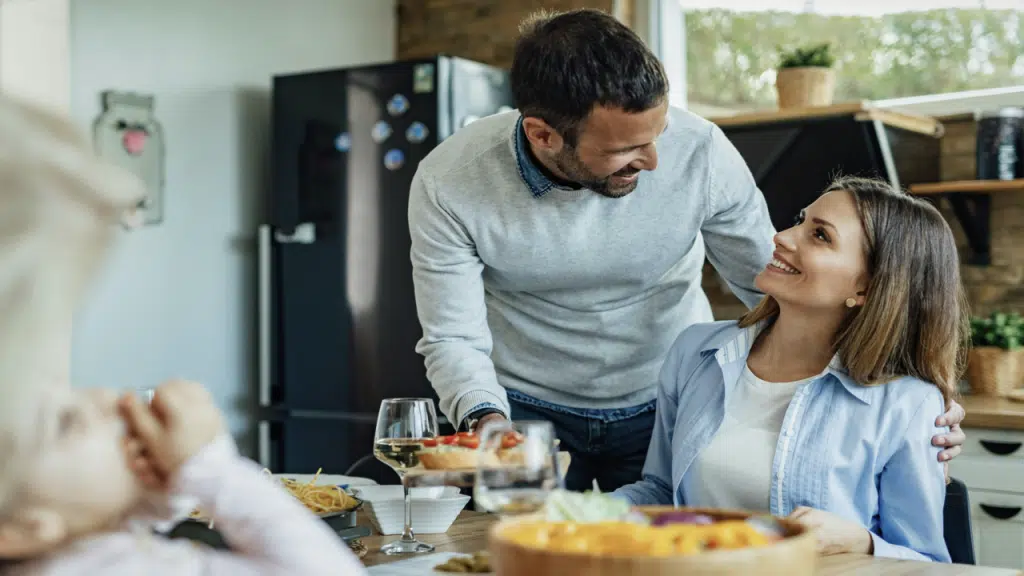 A couple talking to his wife during a family lunch