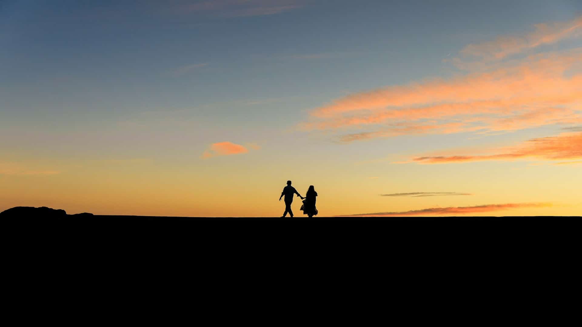couple walking together at sunset