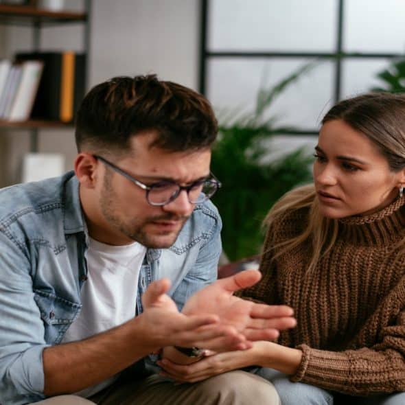 couple having serious conversation indoors