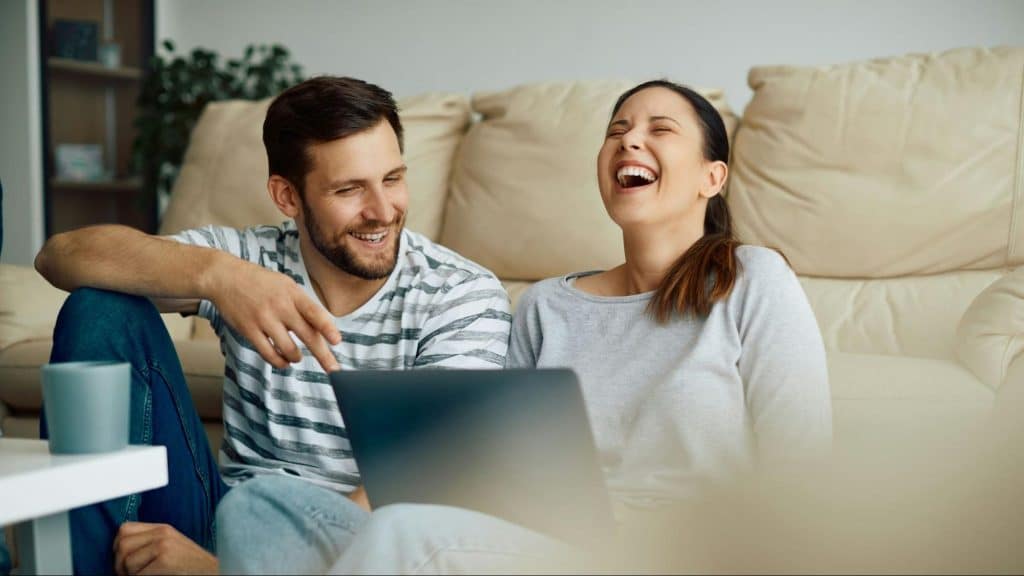 A man and woman using a laptop 