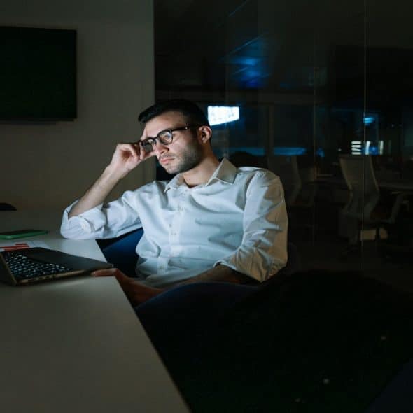 man working late at laptop