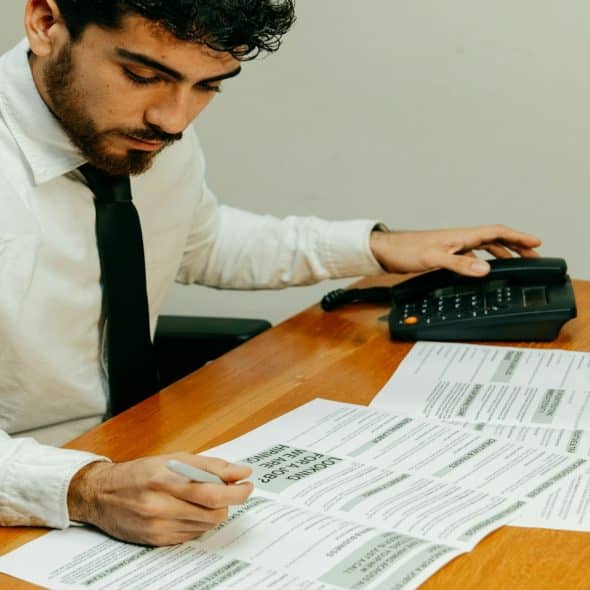 man reviewing finances at desk