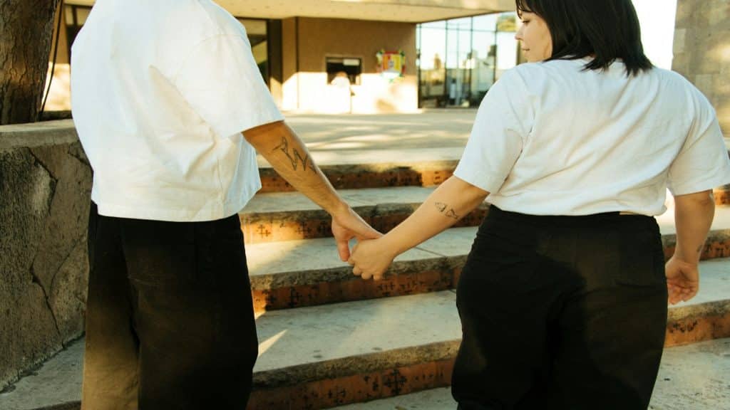 couple holding hands walking together