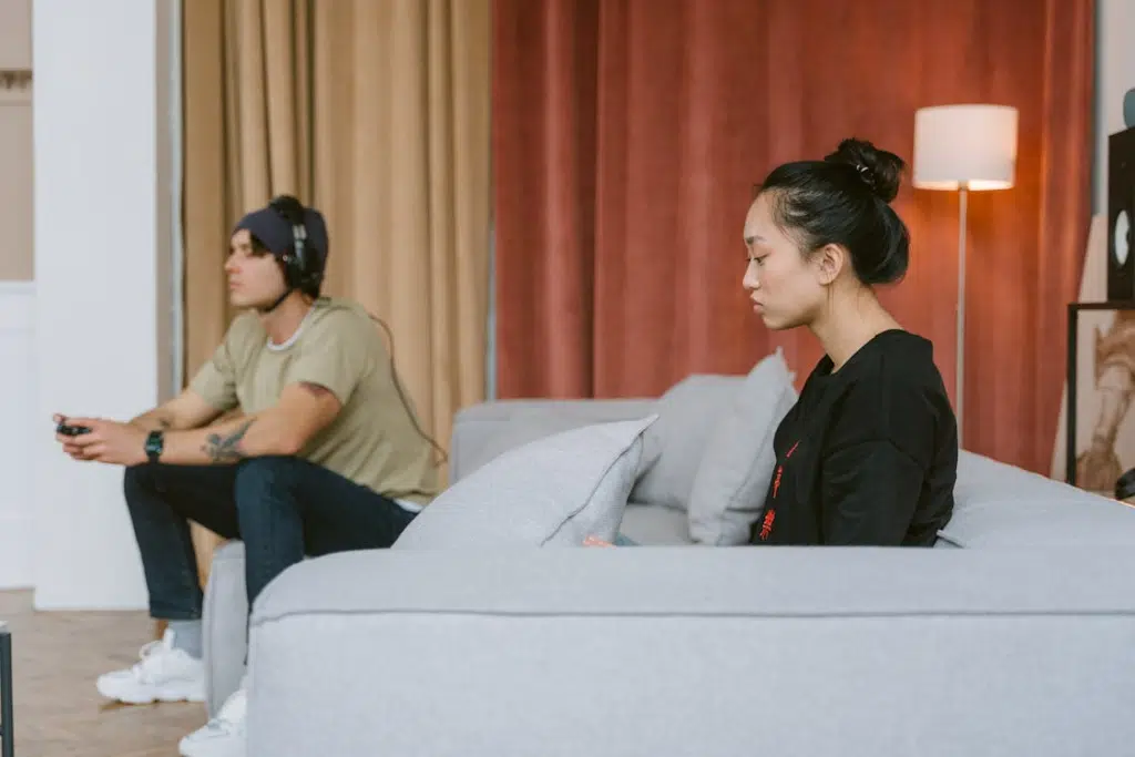 A Sad Woman Sitting on a Couch Near a Man