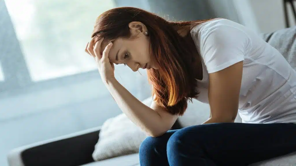 A woman looking sad at home
