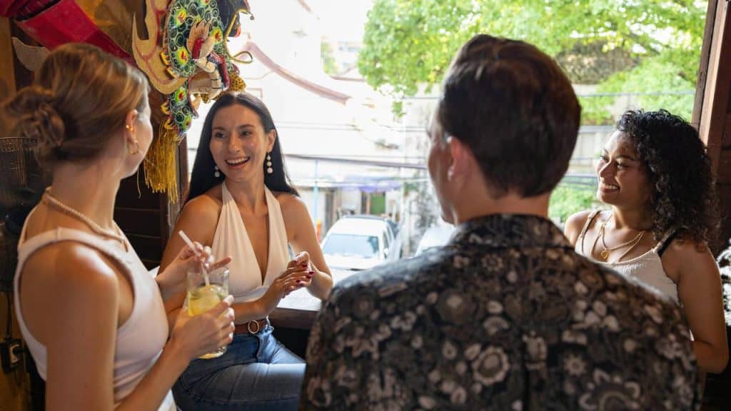 A group of friends chatting and smiling together at a café.