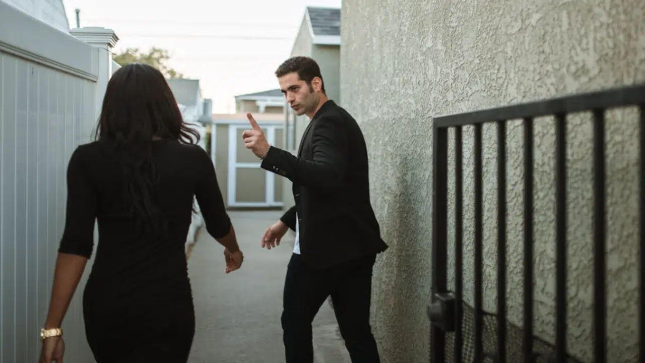 A couple arguing outside their home