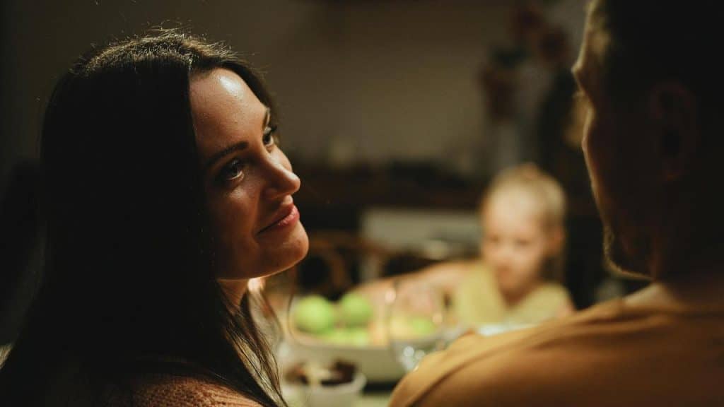 A woman gazing warmly at a man