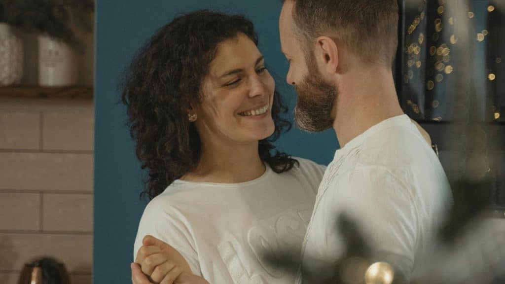 A smiling couple standing close together