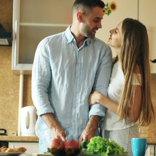 A couple talking in the kitchen