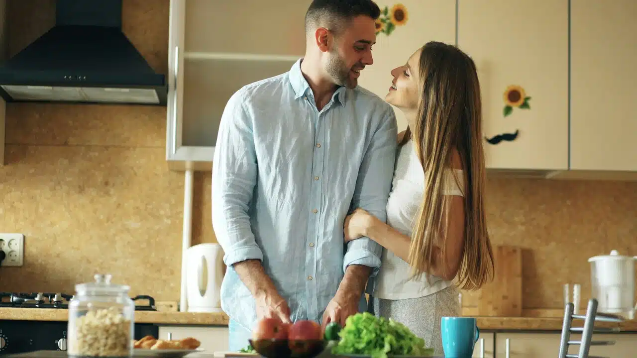 A couple talking in the kitchen