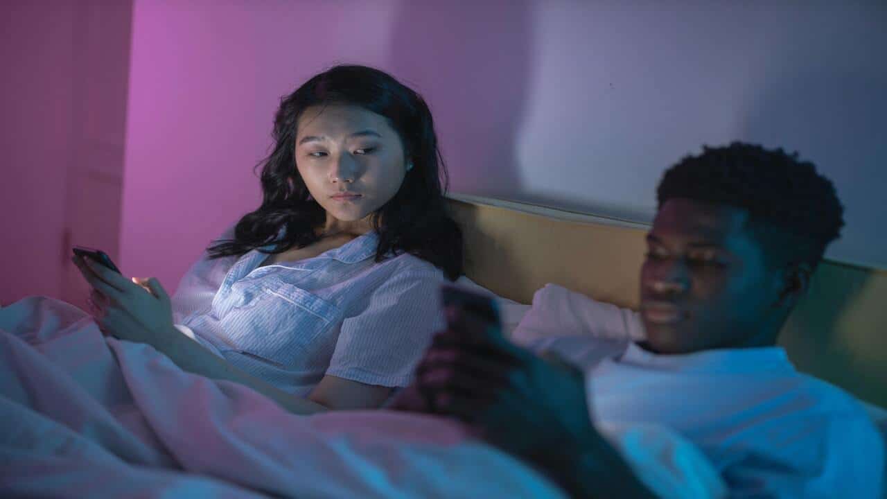 A woman worrying about who her boyfriend is texting