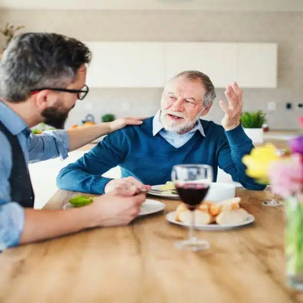 A father and an adult son having a meal at home