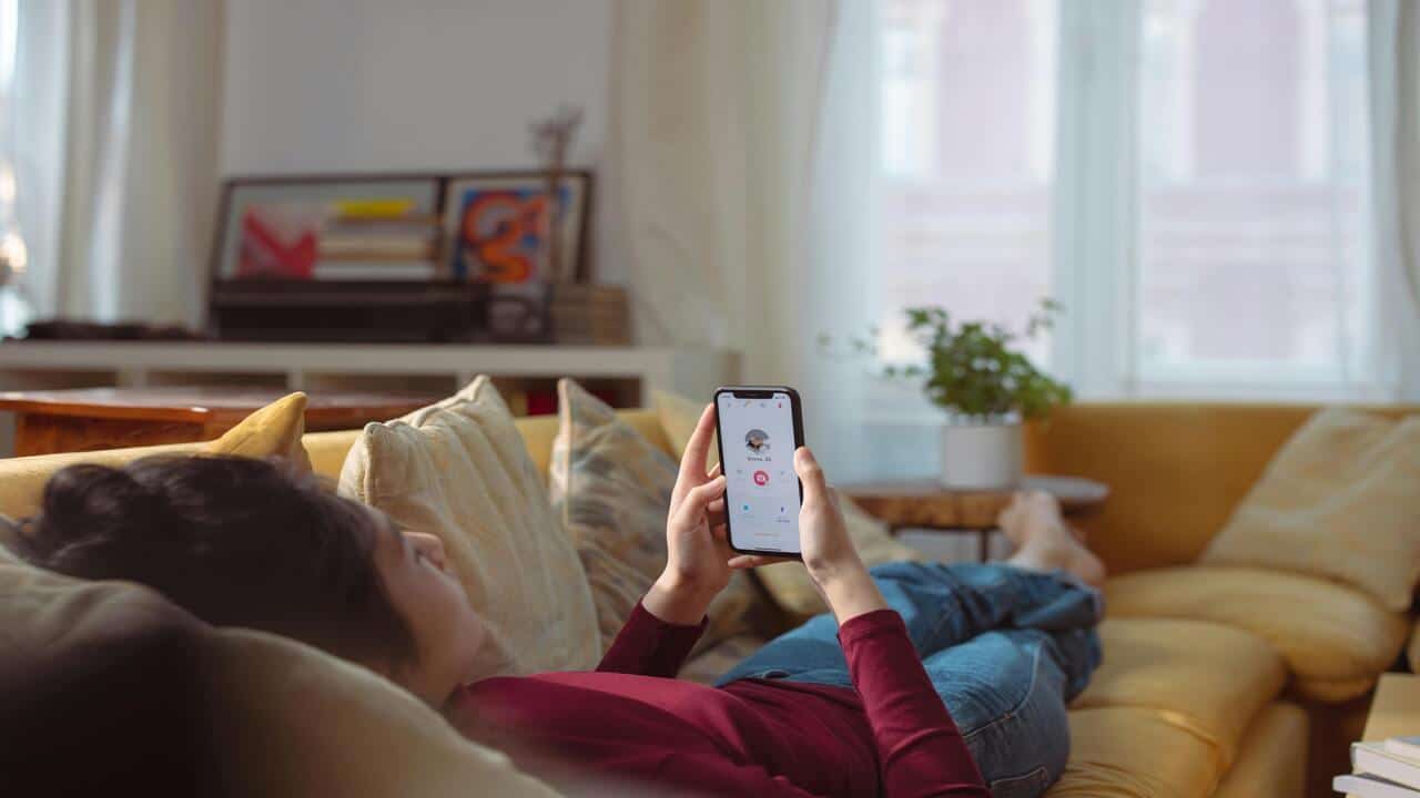 A woman swiping through a dating app