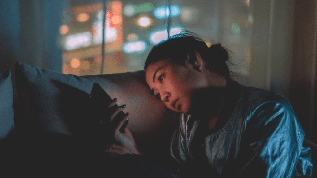 A woman looking sadly at her phone