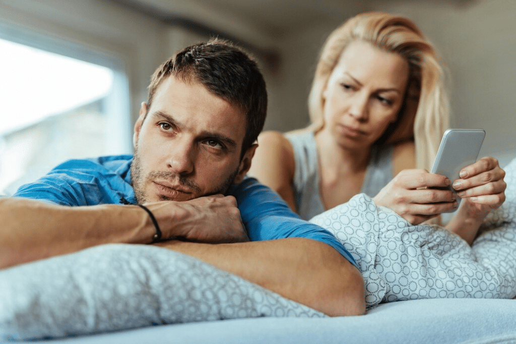A displeased man lying on the bed