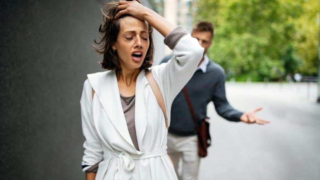 A man and a woman arguing outdoors.