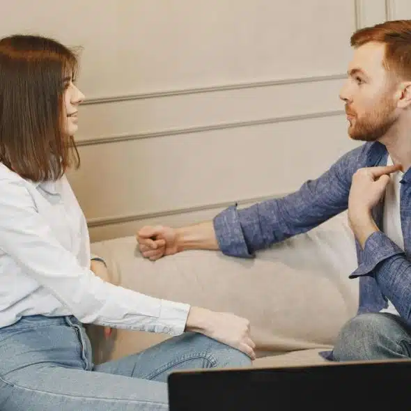 A man and woman sitting on a couch