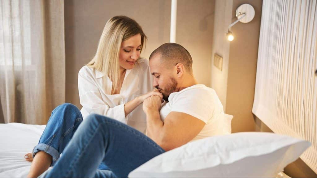 Man kissing woman’s hand