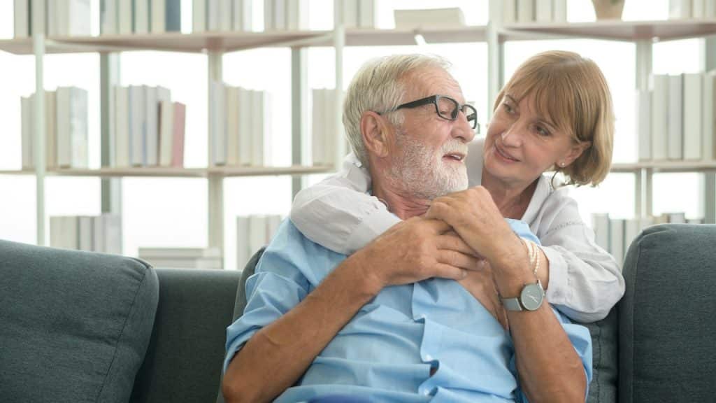 Senior couple relaxing in living room at home.
