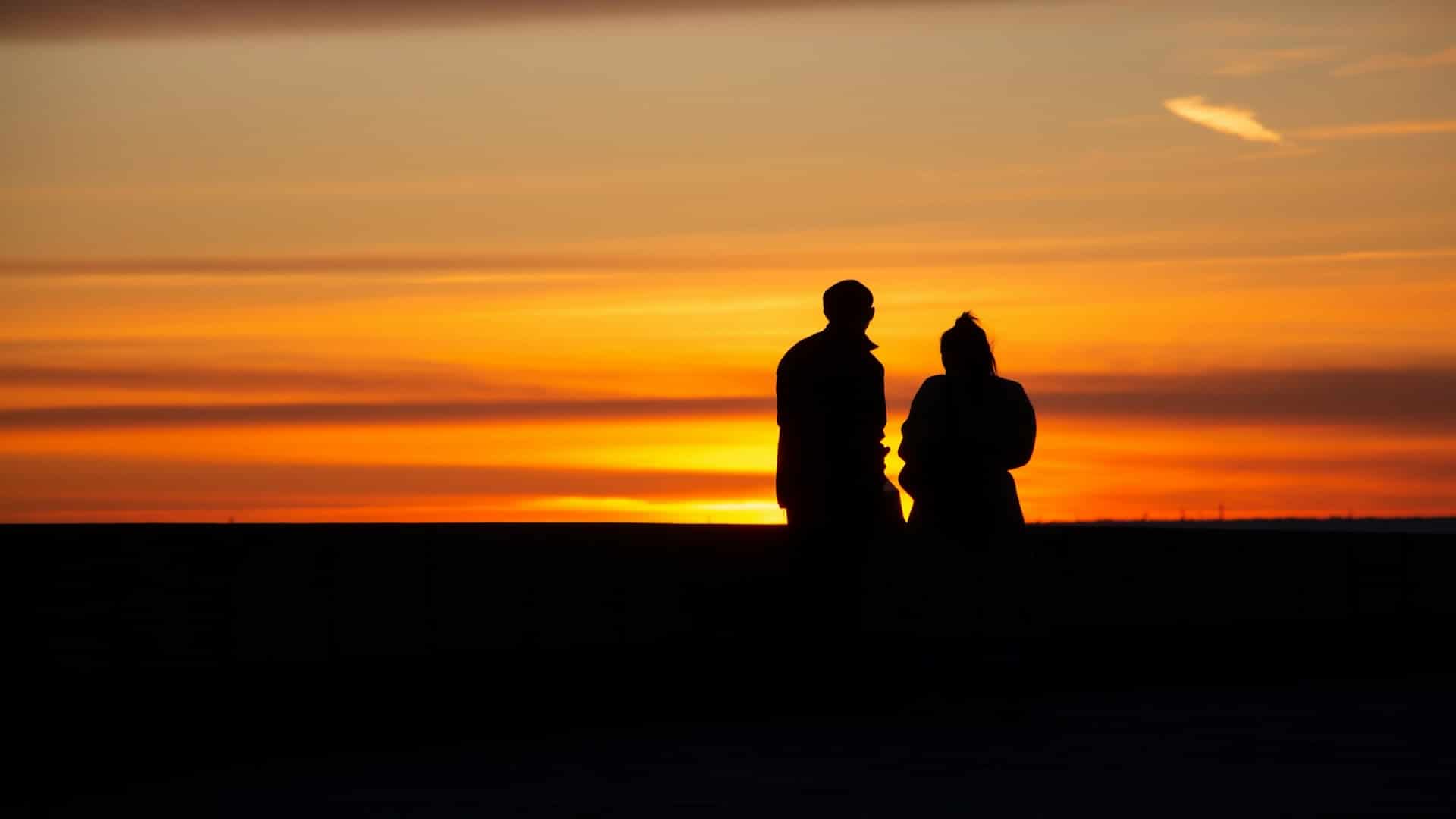 couple standing together at sunset