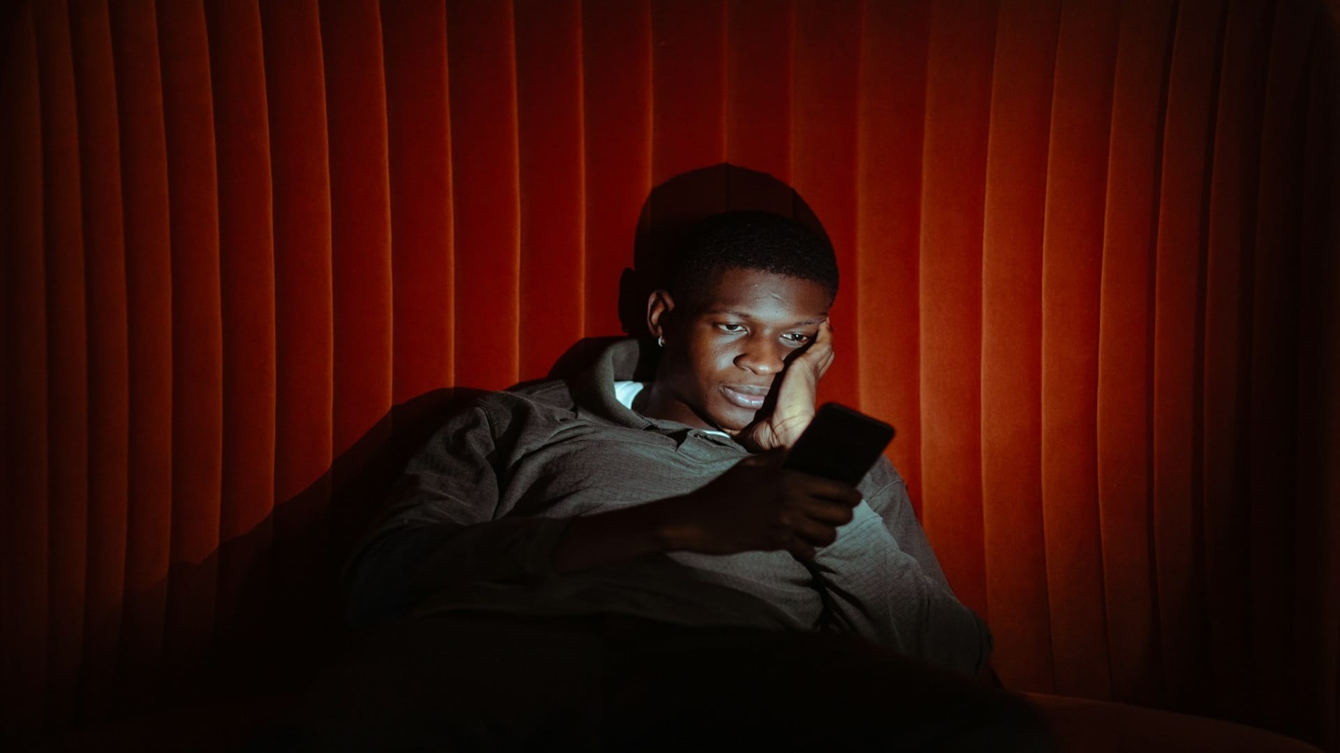 man checking phone late at night