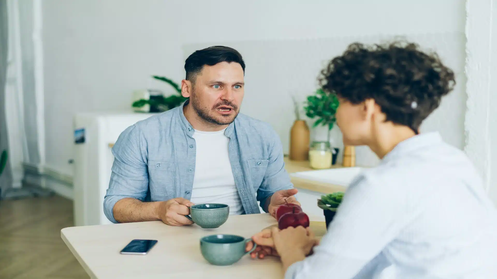 couple discussing disagreement at table