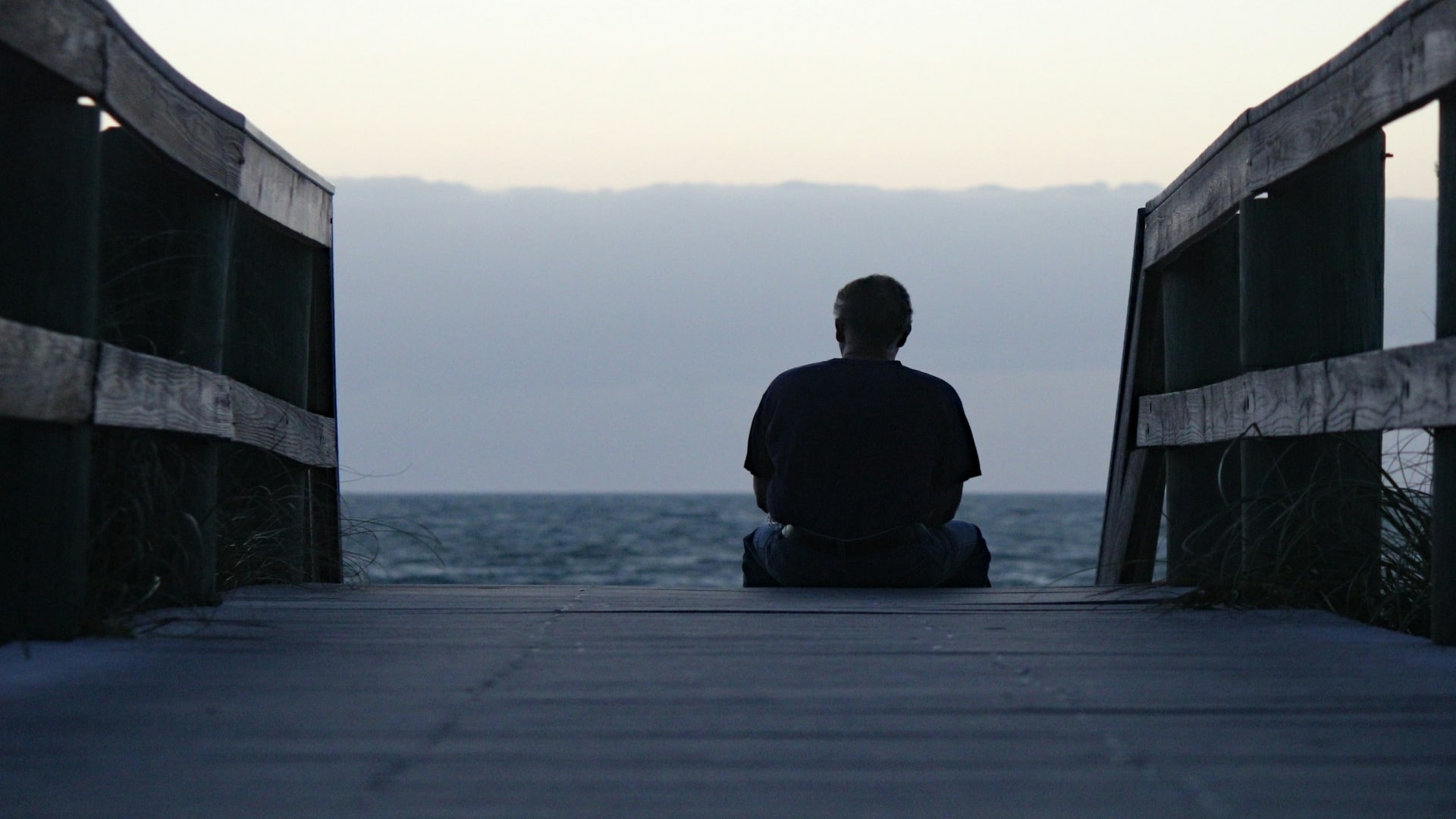 man sitting alone thinking