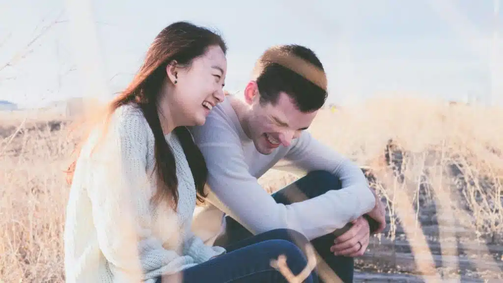 A couple laughing together. 
